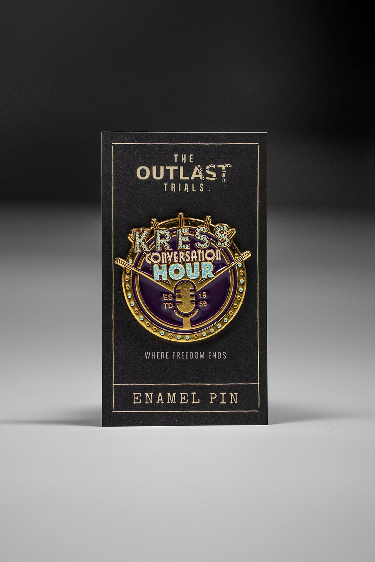 Enamel pin packaging for 'The Outlast Trials' with a dark background