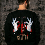 A man viewed from behind wearing a black crewneck sweatshirt with a large graphic print on the back. The graphic features a dripping red skull, white gloved hands forming an 'OK' sign, and the text 'PROGRAM GEISTER'.